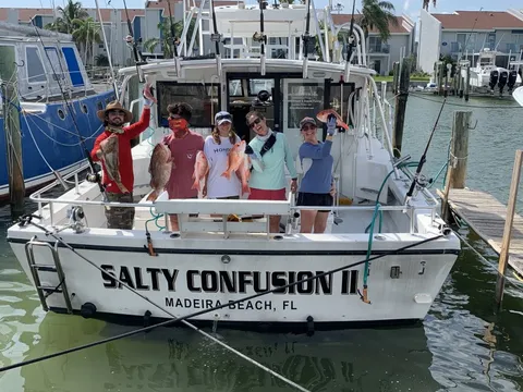 A group of anglers standing on the Salty Confusion II at her dock